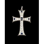 A cross-shaped pendant Set in platinum with oval cut sapphires, one oval cabochon sapphire, rose cut