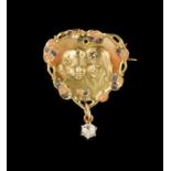 A brooch Gold decorated in relief with two feminine faces, set with one rose cut and one old mine