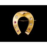 A "horse shoe" brooch Set in gold with rubies and rose cut diamonds Portugal, late 19th, early