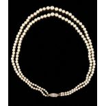 A pearl neckalce Two rows of cultured pearls of decreasing size, gold and platinum clasp set with