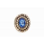 A ring 18kt gold set with one oval cut blue paste and rose cut diamonds Work of the first half of