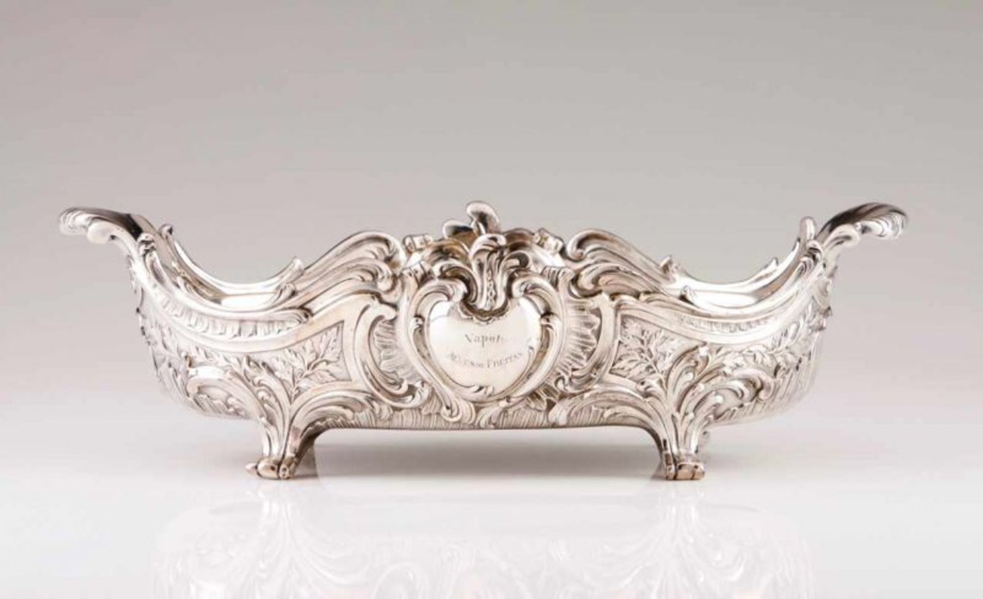A Belle Époque centrepiece Silverplated with rocaille decoration in relief and central cartouche