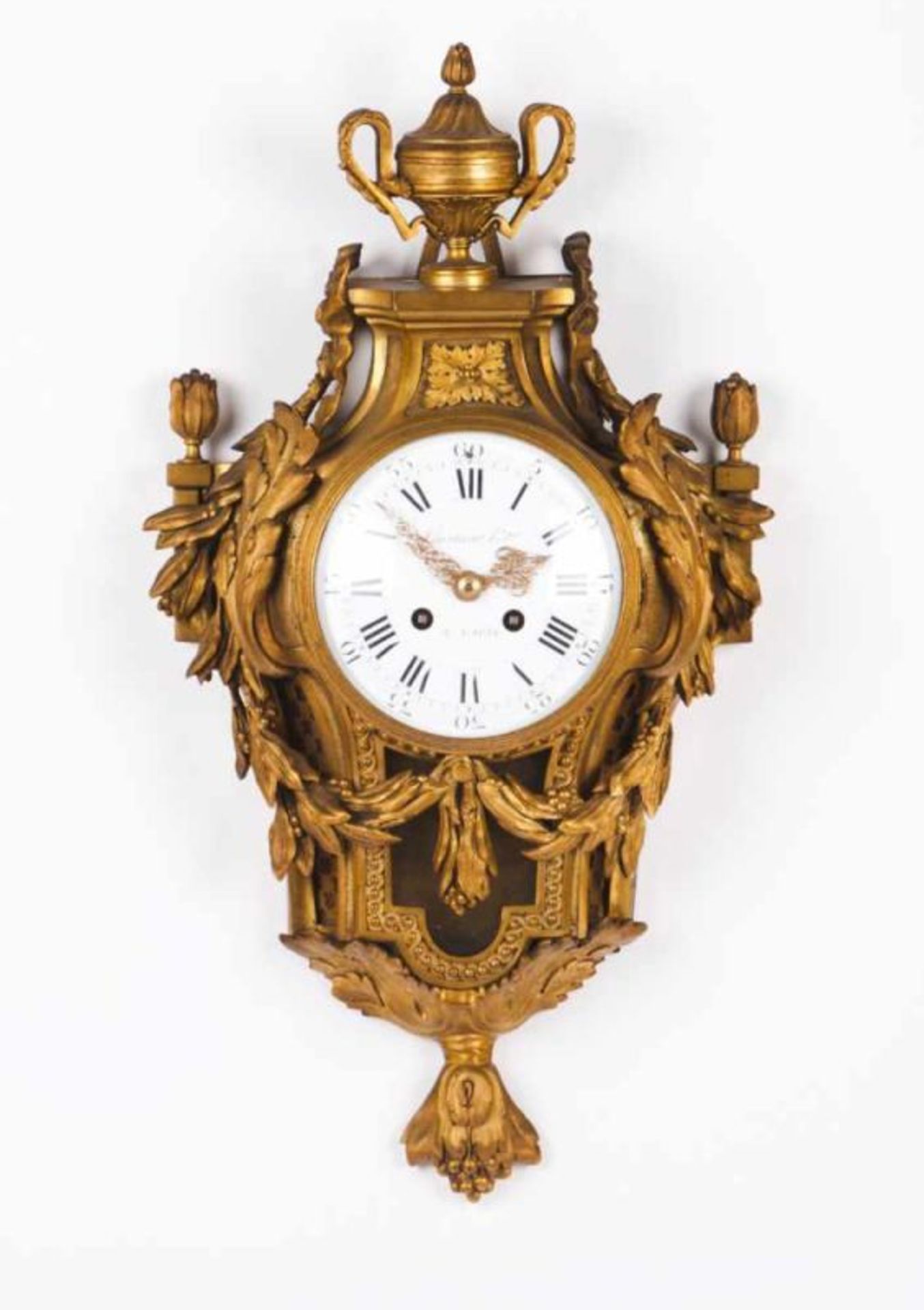 A Louis XVI style wall clock Bronze decorated in relief Enamel dial with roman numbers and