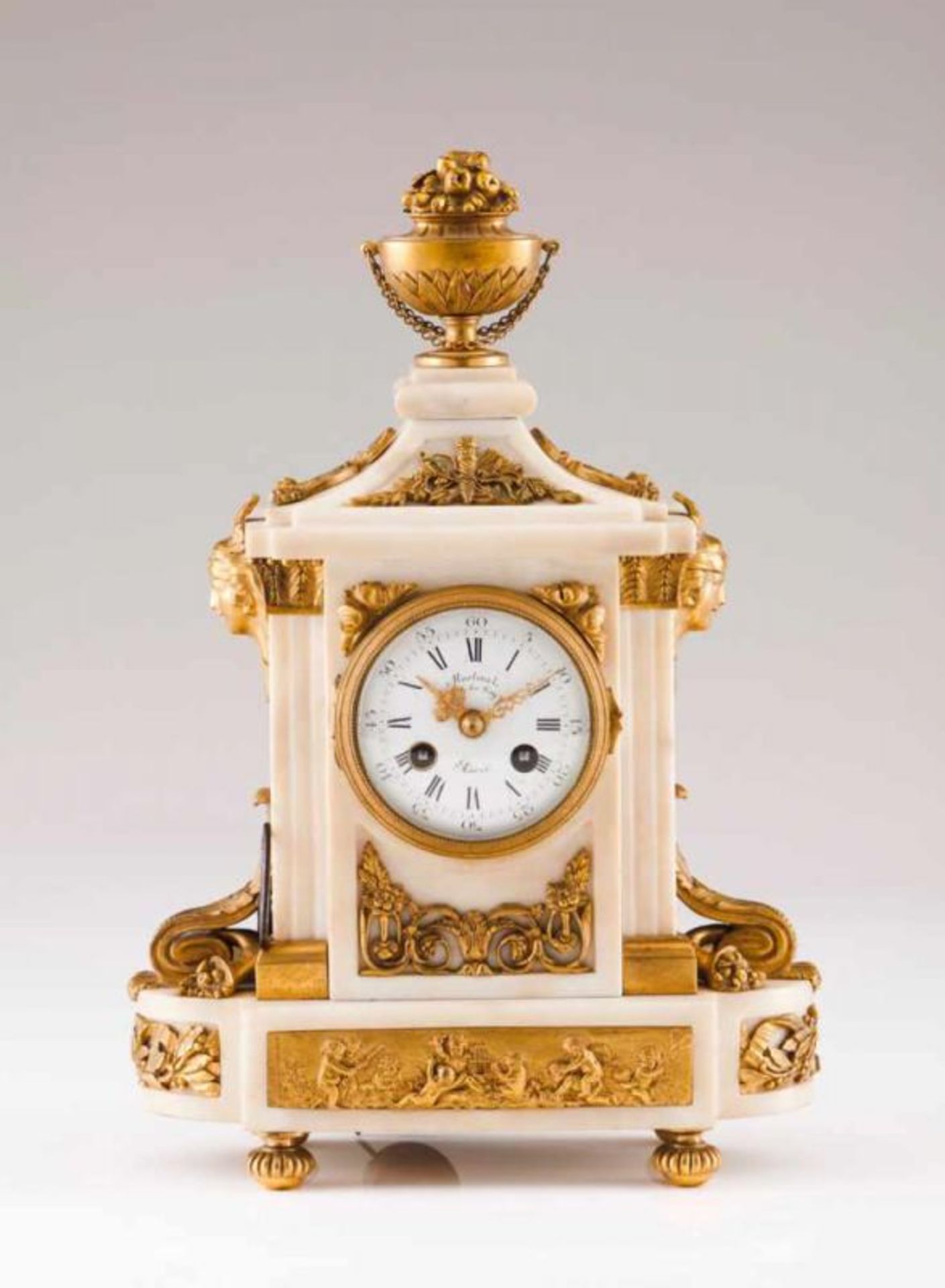 A Louis XVI style table clock White marble case with gilt bronze mounts decorated in relief with
