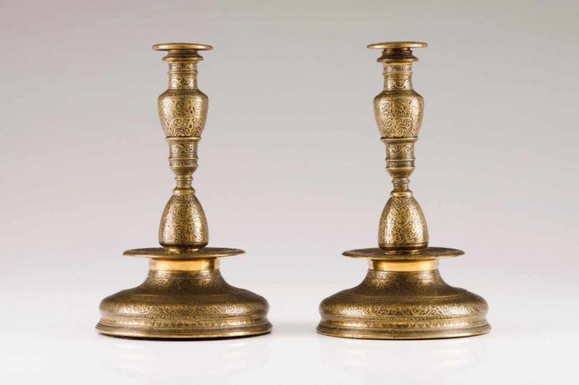 A pair of candlesticks Brass with engraved decoration After the 18th century Italian islamic-