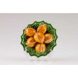 A plate with walnuts Portuguese faience, Caldas da Rainha Green and brown glazing Mark of José Alves