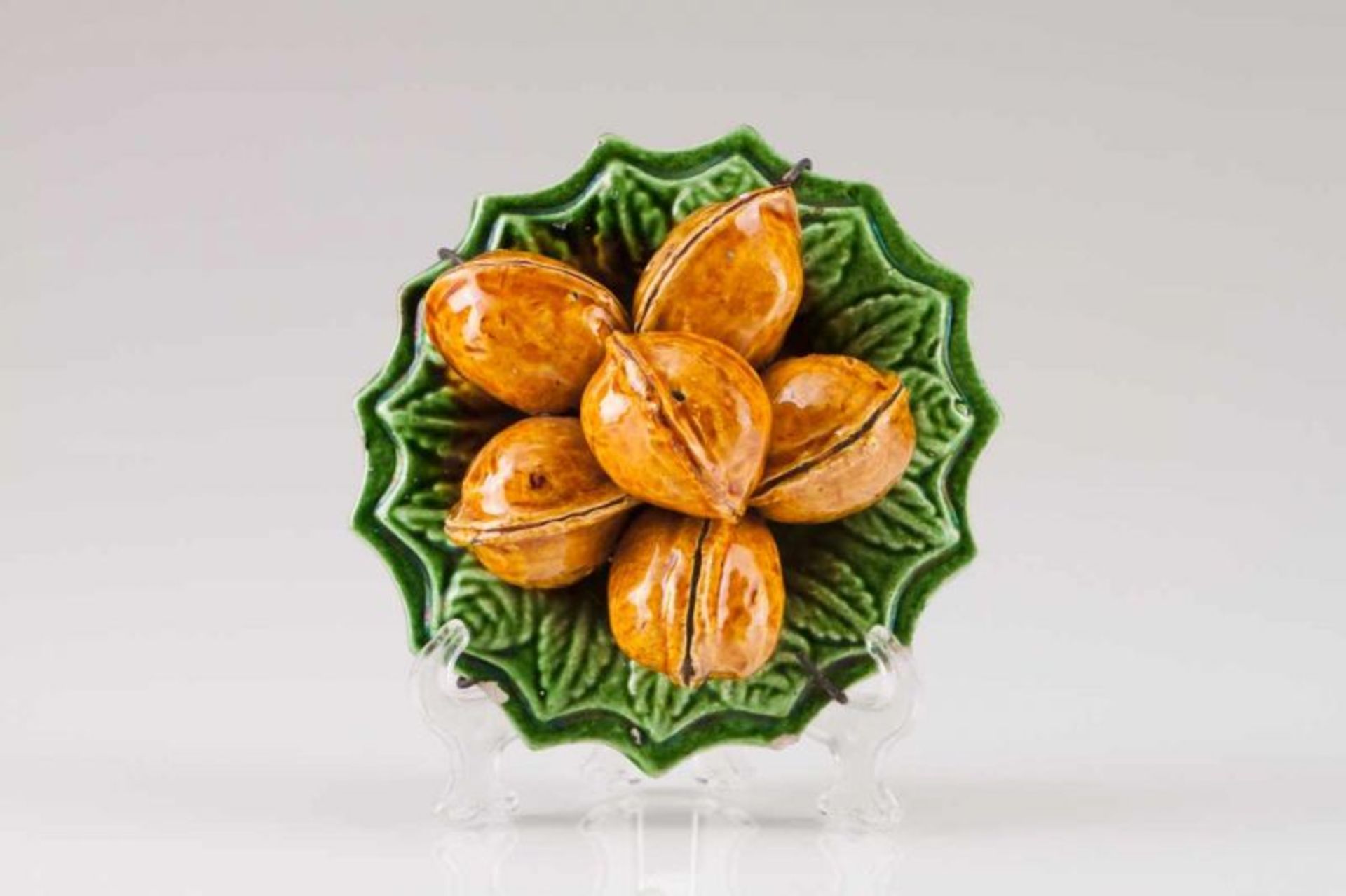 A plate with walnuts Portuguese faience, Caldas da Rainha Green and brown glazing Mark of José Alves
