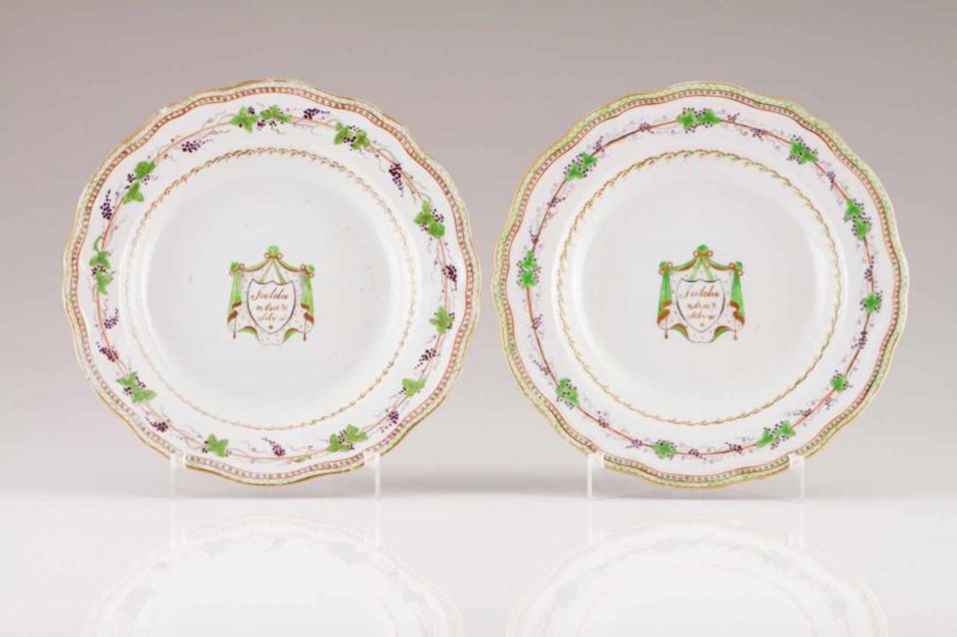 A pair of scalloped soup plates Chinese export porcelain Polychrome and gilt decoration, depicting