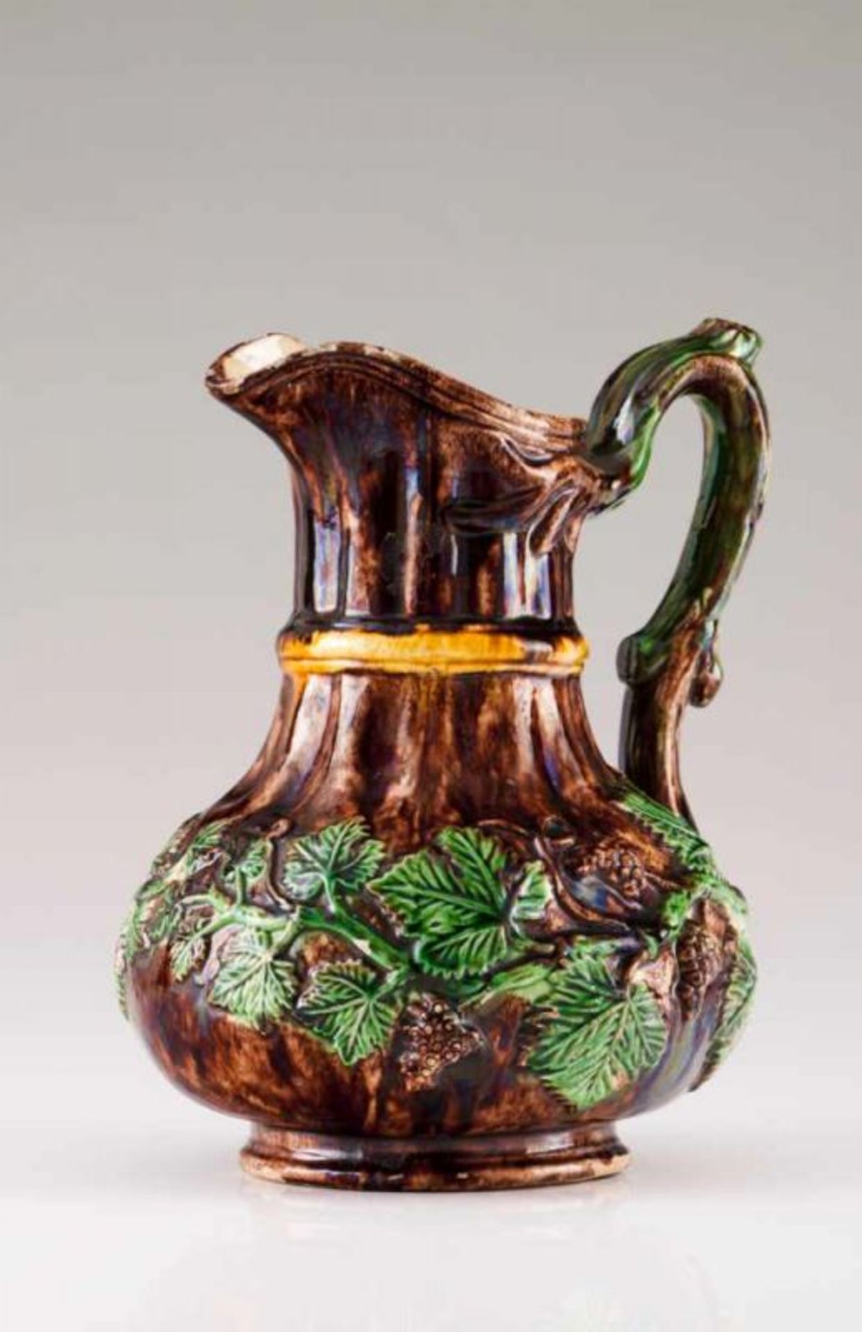 A jug Portuguese faience, Caldas da Rainha Decorated in relief with grapevines with grapes, brown