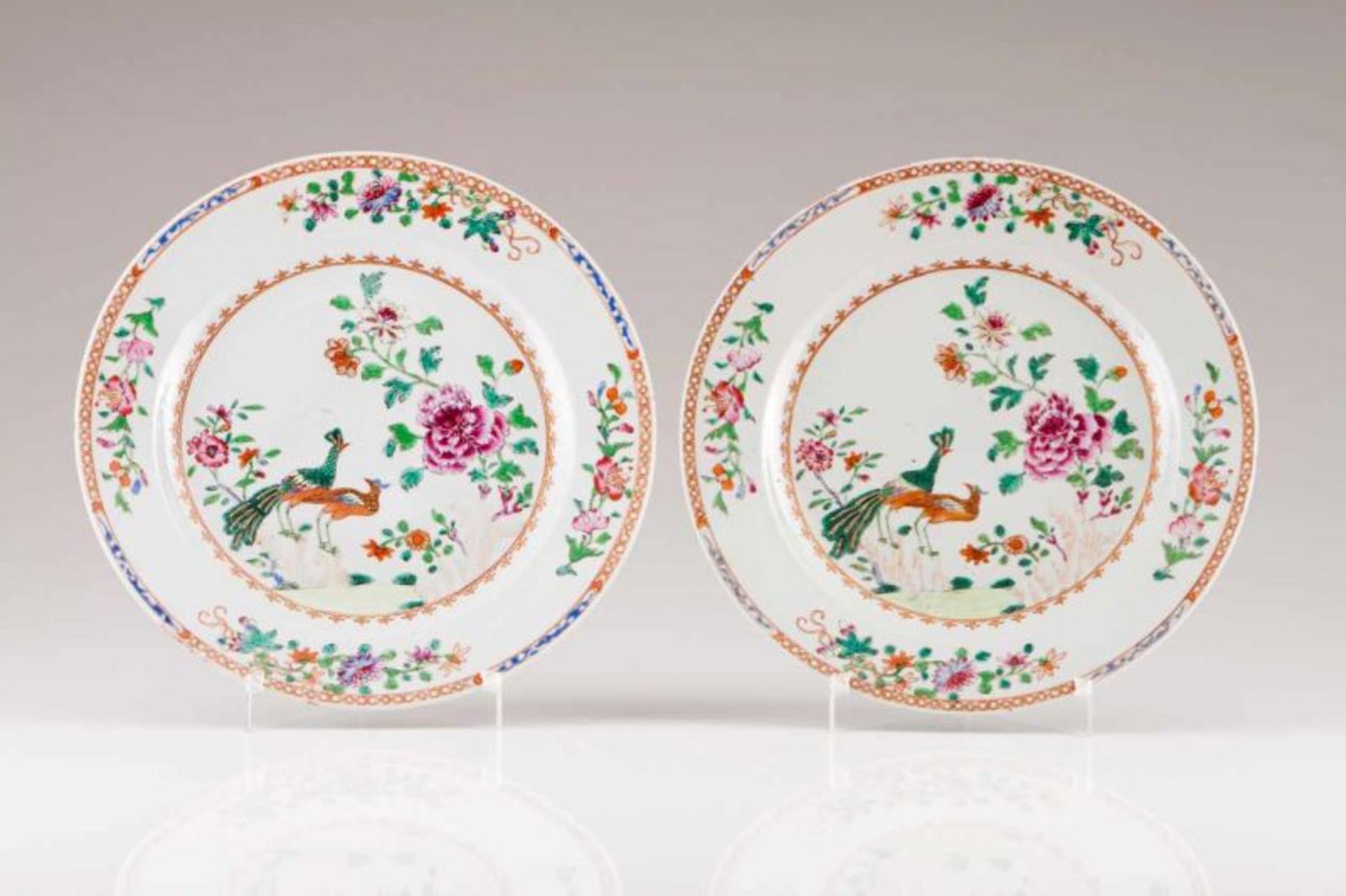A pair of chargers Chinese export porcelain Polychrome and gilt Famille Rose decoration depicting