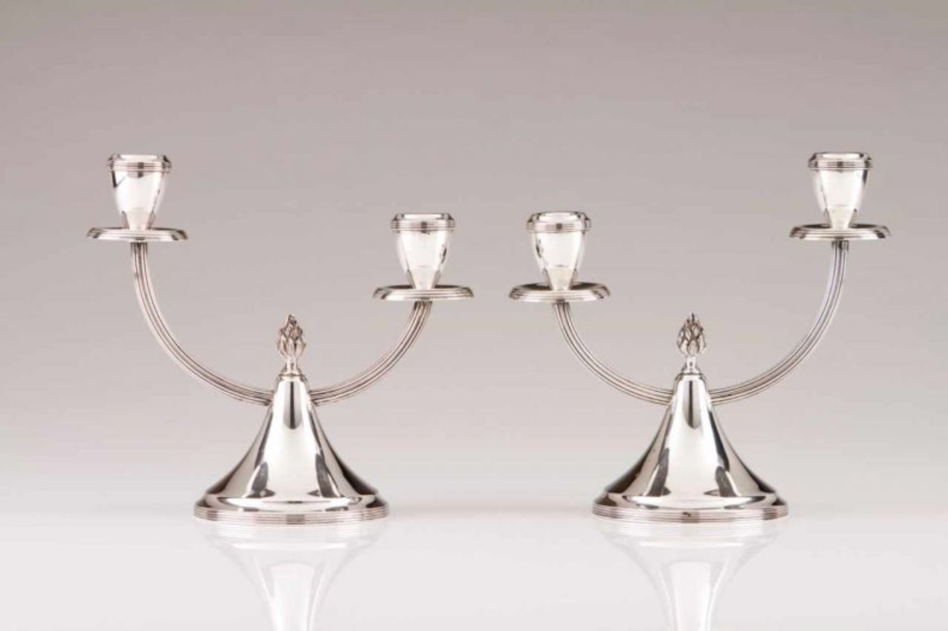 A pair of two-light candelabra Portuguese silver Conical bases with cresset finial, fluted arms