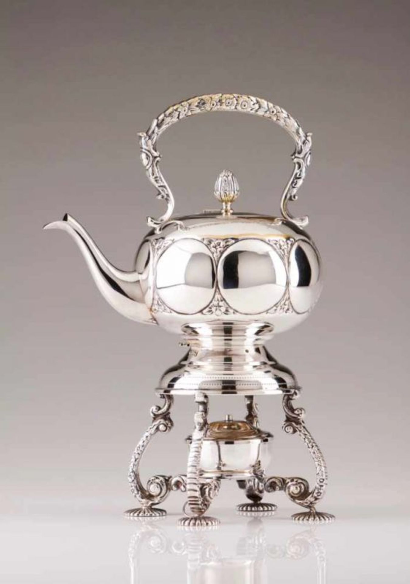 A kettle Silver plated On a stand with four legs decorated in relief, tea pot decorated in relief