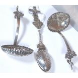 Two continental sugar sifters and a silver tea strainer