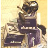 Four boxed new multiplier reels, two Oku