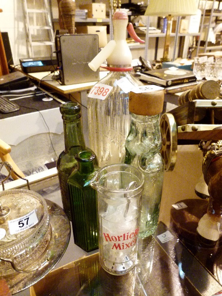 Collection of glass bottles and a soda syphon