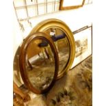 Two oval framed mirrors