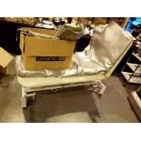 Cream leather electrically adjustable treatment couch with controls,