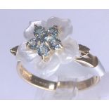 9 ct gold blue stone fancy flower head ring,