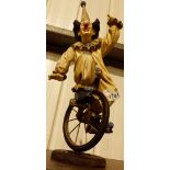 Signed clown figure on unicycle