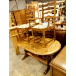 Oak extending dining table with four chairs including two carvers