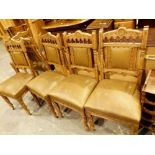 Set of six Edwardian carved oak upholstered dining chairs