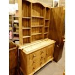 Antique heavy pine kitchen dresser with single cupboard three drawer and multi shelf display top,