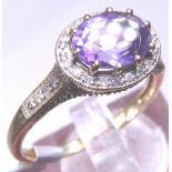 9ct gold amethyst solitaire in diamond set mount,