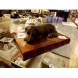 Decorative Spelter dog lying on book