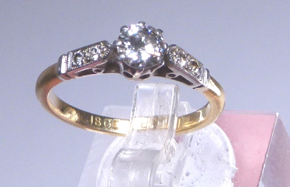 18ct gold diamond solitaire with diamond shoulders, approximately 0.