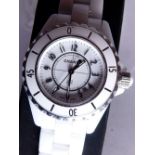 Chanel ladies white model J12 wristwatch on white ceramic bracelet with stone mounted crown.