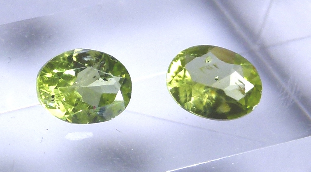 Pair of oval cut peridot stones, approximately 2.