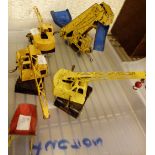 Three Dinky Coles mobile cranes and elevator loader with wheelbarrow