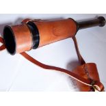 Brass telescope in brown leather case