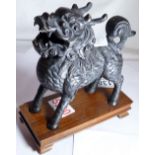 Bronze dragon censer on wooden stand,