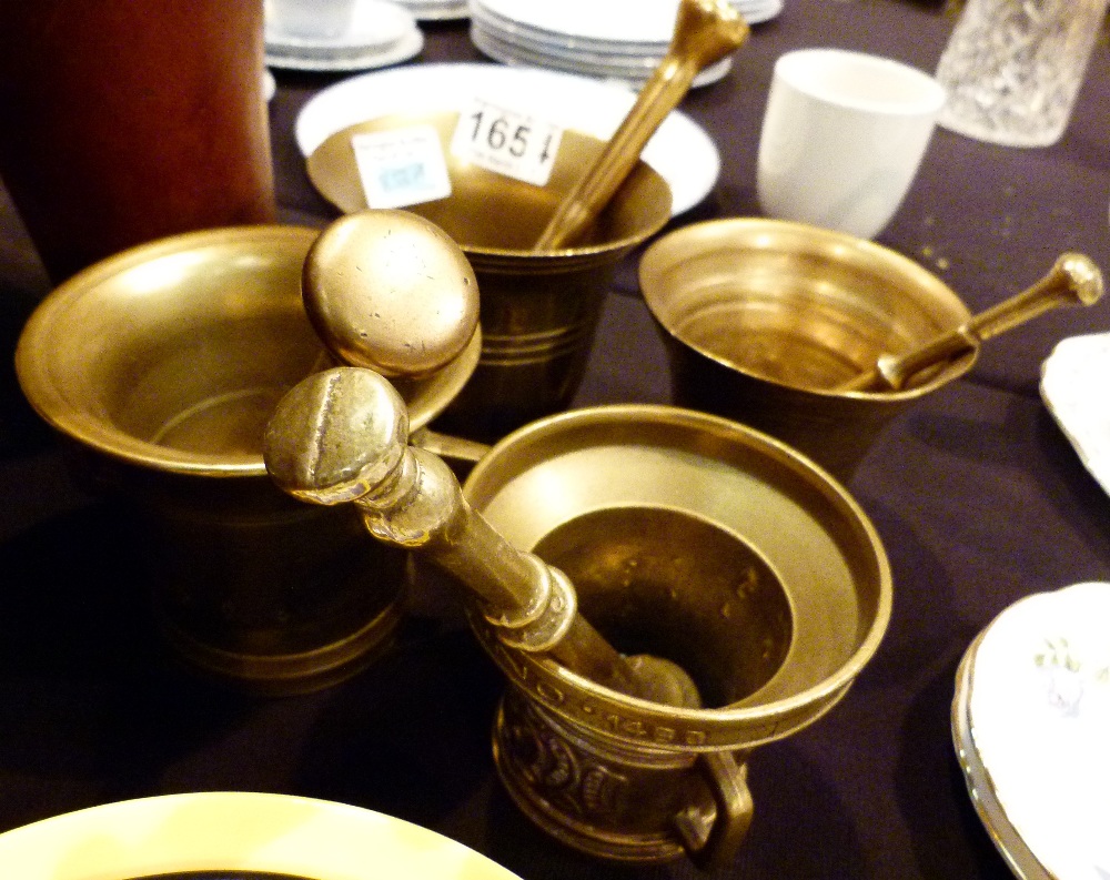 Four brass pestle and mortars