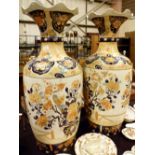 Pair of oriental Imari coloured vases with birds and flowers with fluted tops, H: 92 cm,