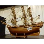 Wooden hull model of a rigged sailing ship on stand