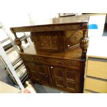 Dark oak heavily carved court cupboard with twin drawers and under cupboards,