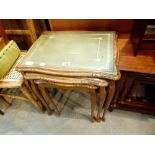 Nest of three glass and green leather top tables