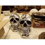 Pair of chrome skulls