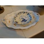 Vintage German shallow bowl with orange and gold design and a Delft dish