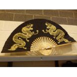 Large oriental black and gold fan