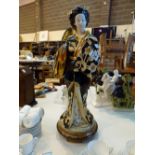 Oriental ceramic figurine of a standing Geisha girl,