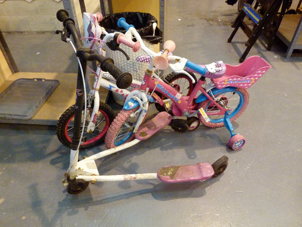 Two childrens bikes and a scooter