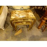 Nest of three brass occasional tables with inset stone tops