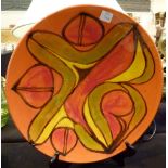 Poole pottery plate on a display stand,