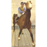 Beswick walking racehorse and jockey, yellow and blue silks,