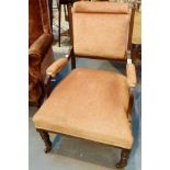 Upholstered nursing chair with turned legs and ceramic castors