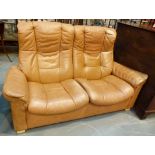 Leather two seater tan coloured settee by Ekornes of Norway