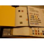 Four worldwide postage stamp album and a box of loose stamps